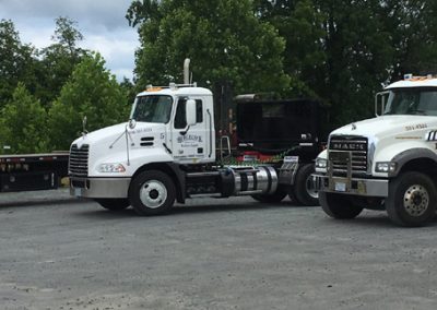 Mack Trucks delivering building supplies